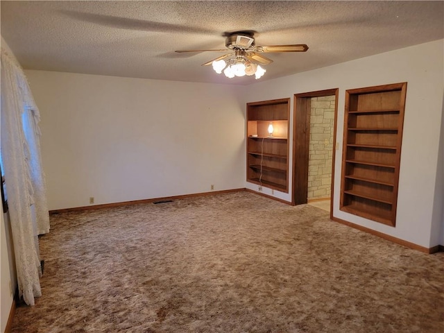 unfurnished bedroom featuring ceiling fan, carpet floors, and a textured ceiling