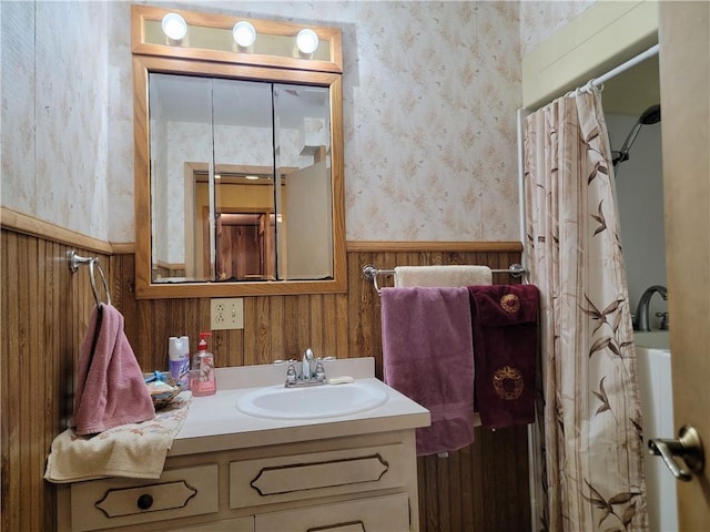 bathroom featuring vanity, shower / bath combination with curtain, and wooden walls