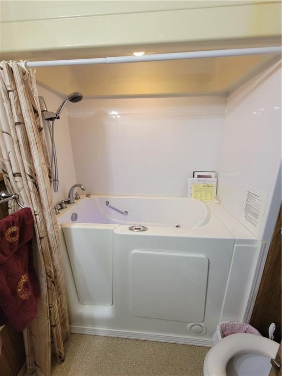 bathroom featuring walk in shower and toilet