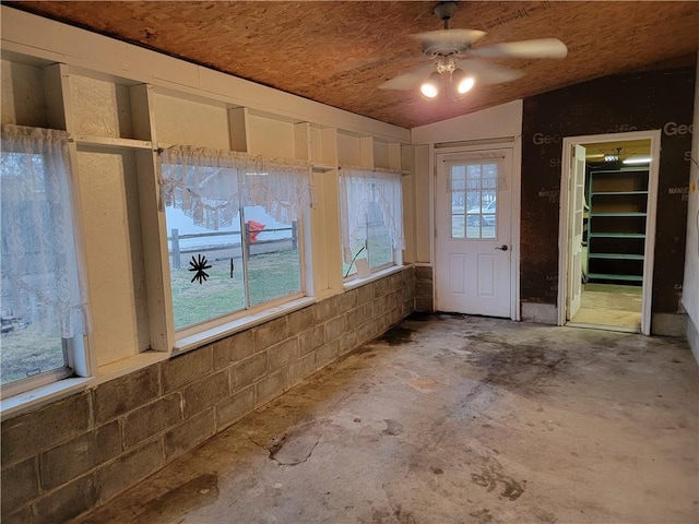 interior space featuring ceiling fan, lofted ceiling, and concrete floors