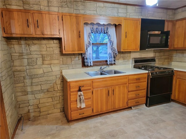 kitchen with backsplash, sink, and black appliances