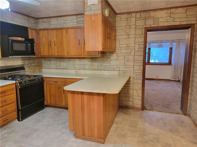 kitchen with tasteful backsplash, kitchen peninsula, and black appliances