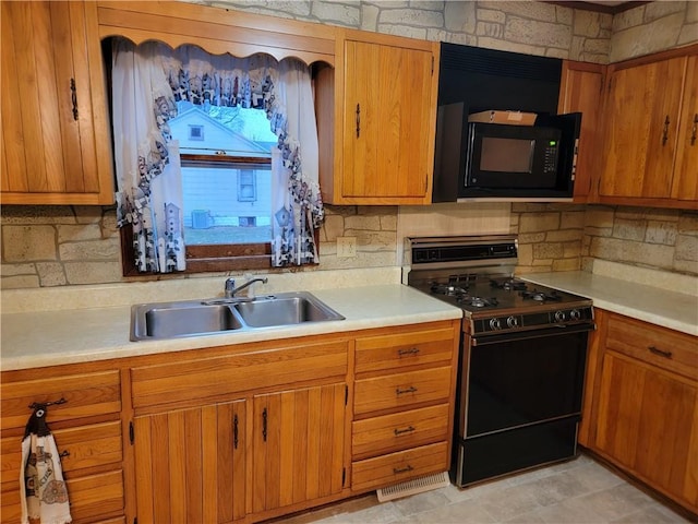 kitchen featuring tasteful backsplash, sink, and black appliances