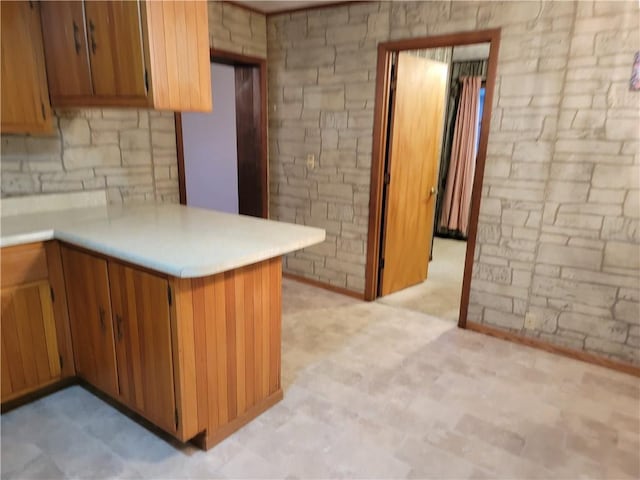 kitchen featuring kitchen peninsula and backsplash