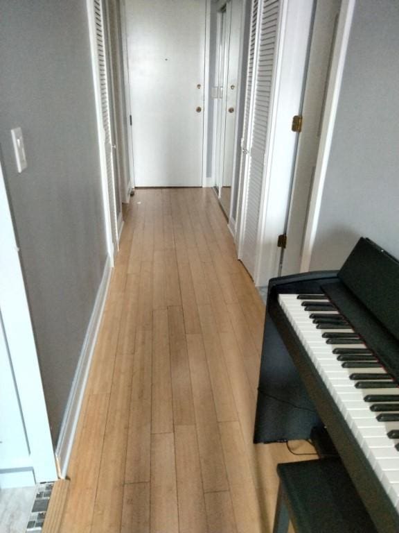 corridor with light wood-type flooring