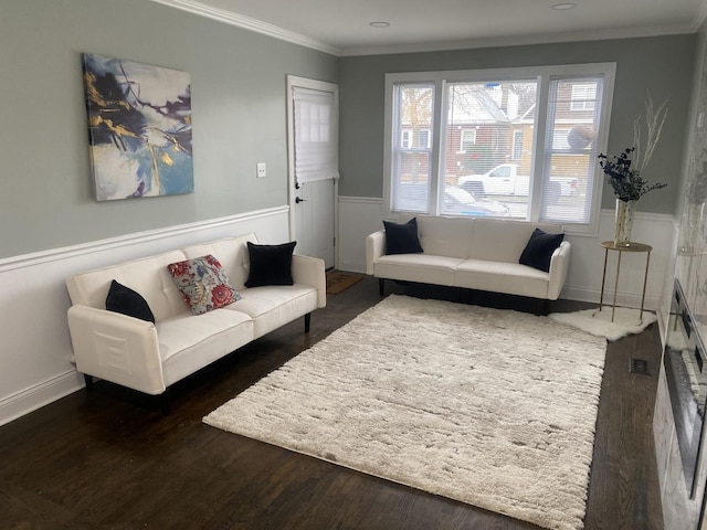 living room featuring ornamental molding and dark wood-type flooring