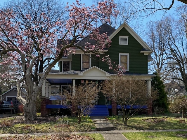 view of property featuring covered porch