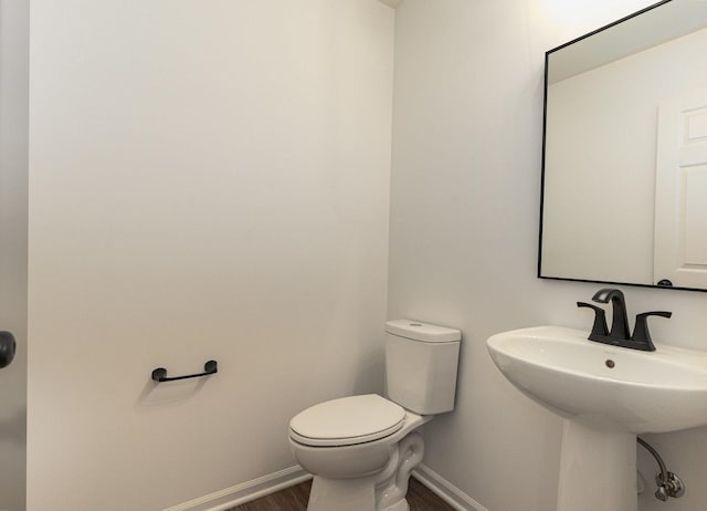 bathroom with wood-type flooring and toilet