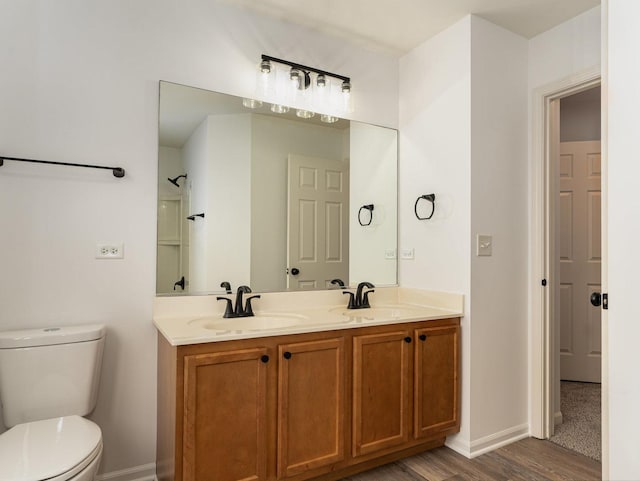 bathroom with vanity, wood-type flooring, and toilet