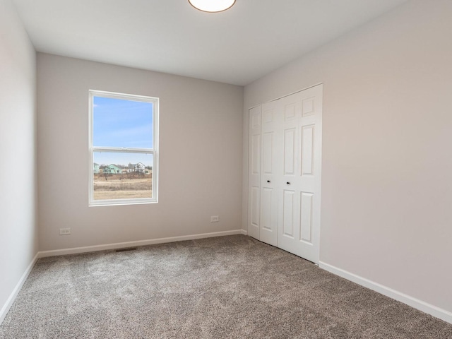 unfurnished bedroom with a closet and carpet flooring