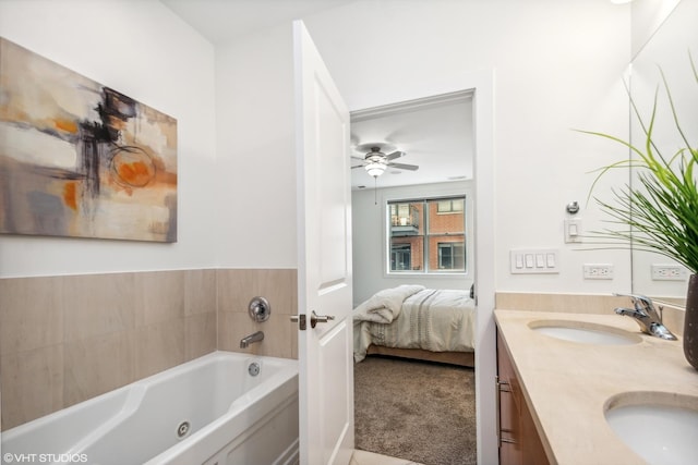 bathroom with vanity, a washtub, and ceiling fan