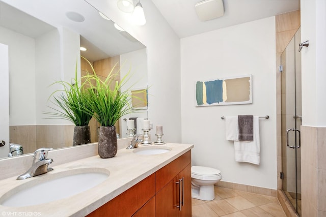 bathroom with tile patterned floors, toilet, an enclosed shower, and vanity