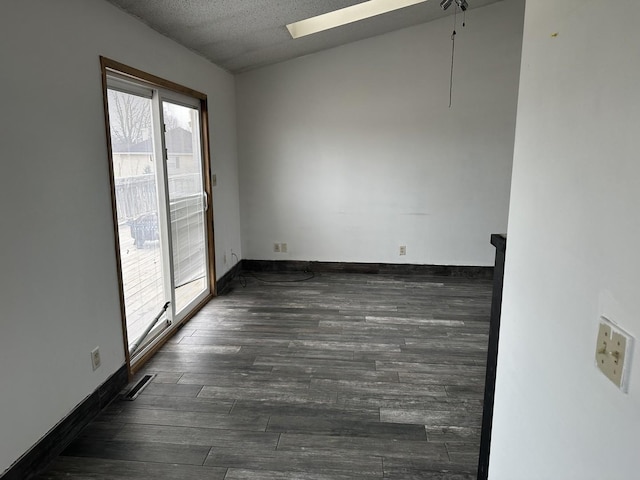 unfurnished room featuring dark hardwood / wood-style flooring and a textured ceiling