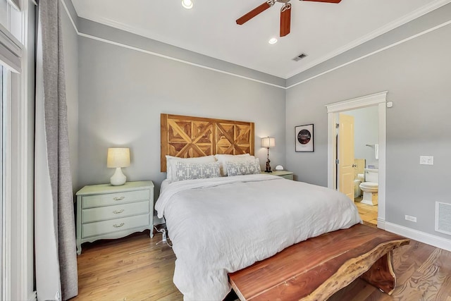 bedroom with crown molding, ceiling fan, light hardwood / wood-style floors, and ensuite bath