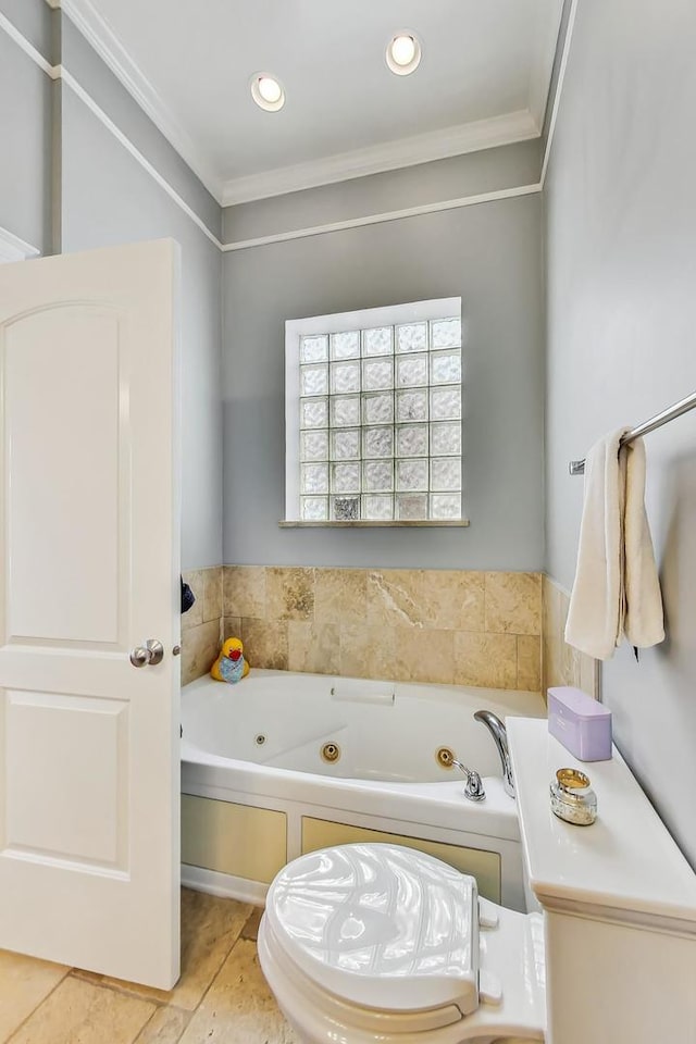 bathroom featuring a tub to relax in and crown molding