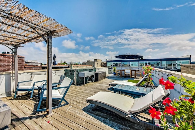 wooden deck with exterior bar and a pergola