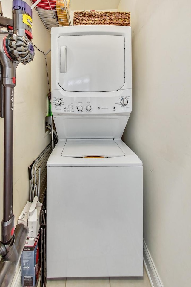 laundry room featuring stacked washer / drying machine