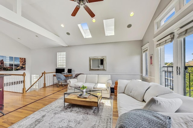 living room featuring wood-type flooring and high vaulted ceiling