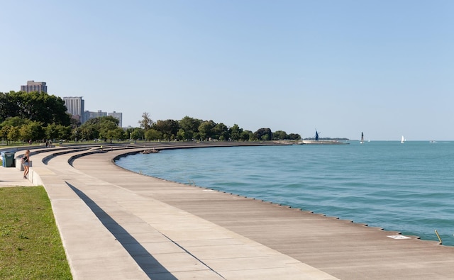 view of swimming pool featuring a water view