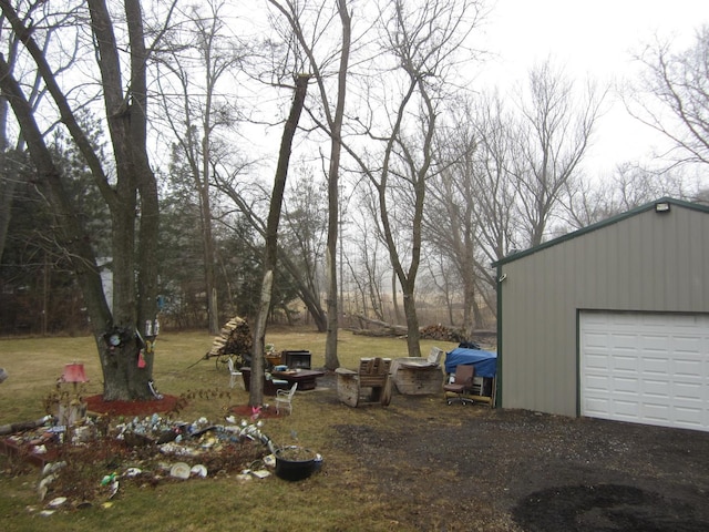 view of yard with a garage and an outdoor structure