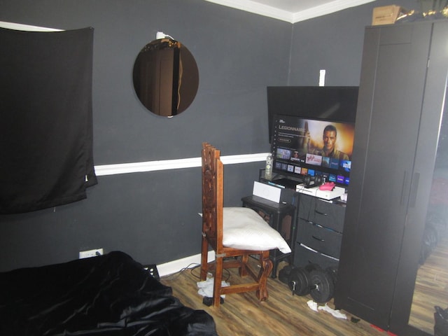 bedroom featuring hardwood / wood-style floors and crown molding