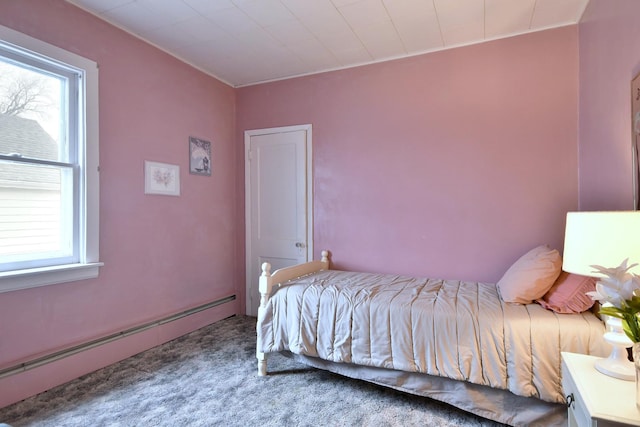 bedroom featuring carpet and a baseboard heating unit