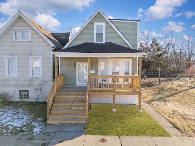 view of front of property with a front yard and covered porch