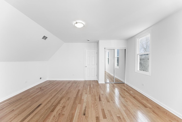 bonus room featuring vaulted ceiling and light wood-type flooring