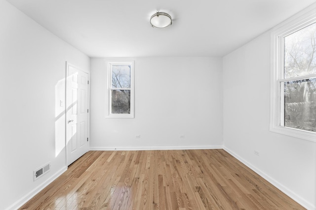 empty room with light hardwood / wood-style flooring