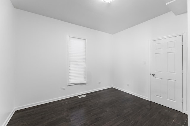 empty room with dark wood-type flooring