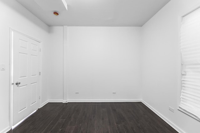 unfurnished room with dark hardwood / wood-style flooring