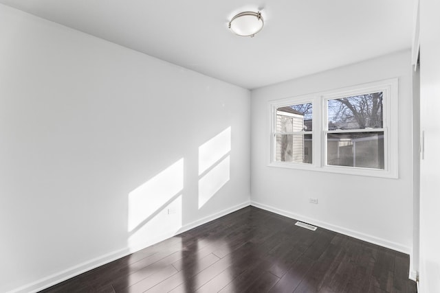 unfurnished room featuring dark wood-type flooring