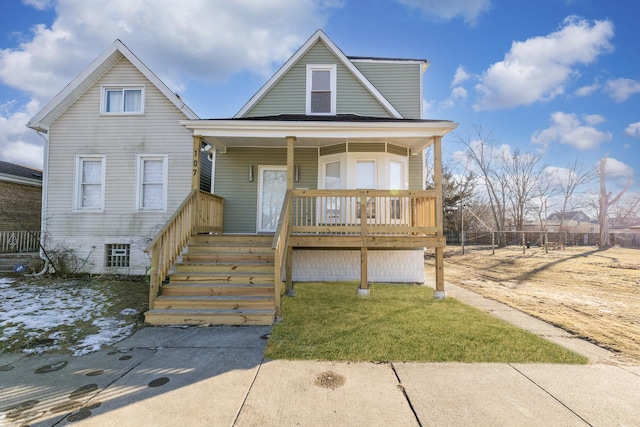 view of front of home featuring a front yard and covered porch