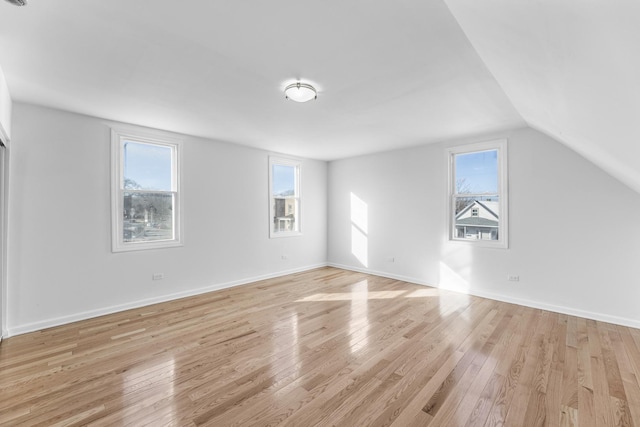 interior space featuring lofted ceiling and light hardwood / wood-style floors