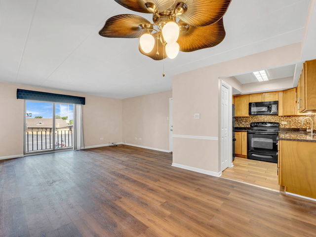 unfurnished living room featuring ceiling fan, sink, and light hardwood / wood-style floors