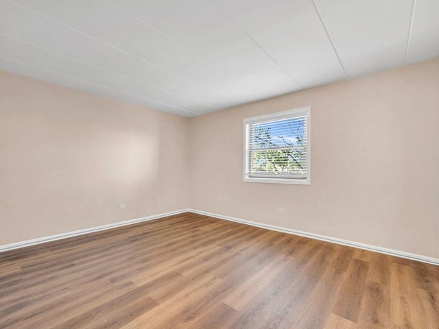 spare room featuring hardwood / wood-style flooring