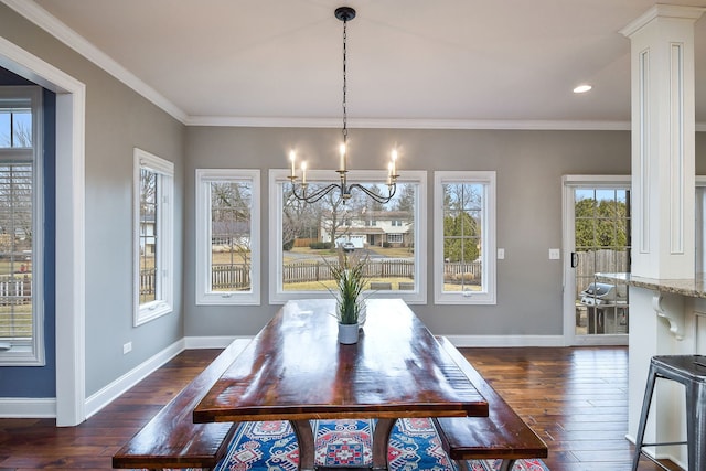 dining room featuring a healthy amount of sunlight, baseboards, and ornamental molding