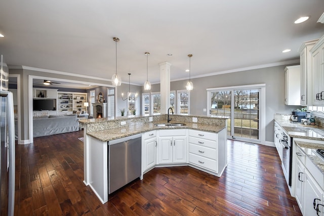 kitchen with dark wood finished floors, a ceiling fan, open floor plan, a sink, and dishwasher