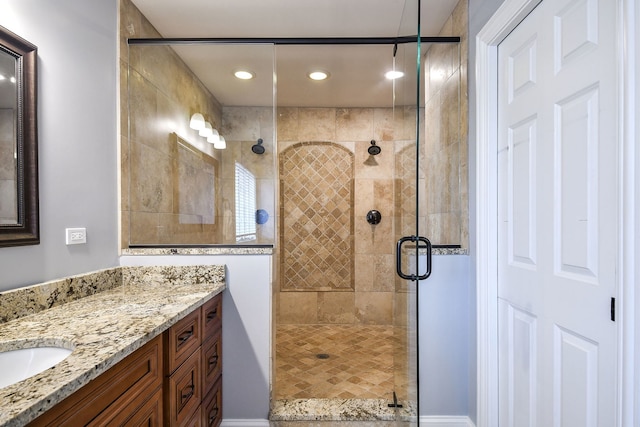 bathroom featuring a shower stall and vanity