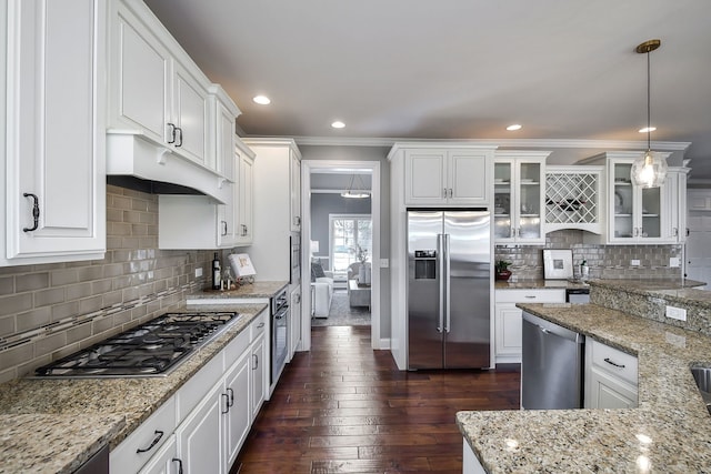 kitchen featuring dark wood-style floors, glass insert cabinets, appliances with stainless steel finishes, under cabinet range hood, and white cabinetry