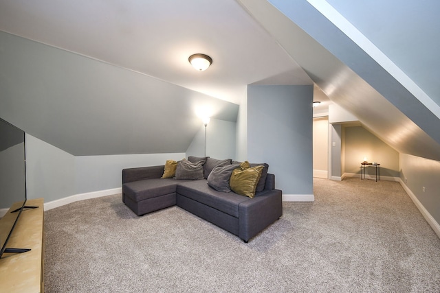 carpeted living room with lofted ceiling and baseboards