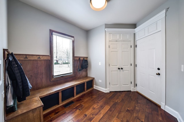 mudroom with dark wood-style floors and baseboards