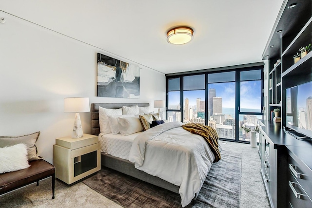 bedroom featuring floor to ceiling windows and light colored carpet