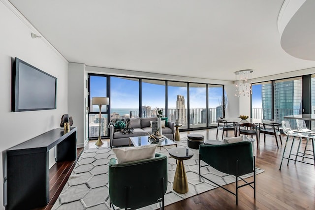 living room featuring an inviting chandelier, hardwood / wood-style flooring, and expansive windows