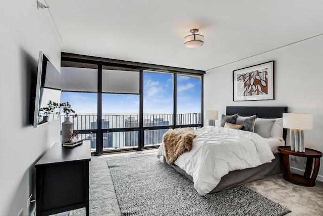 carpeted bedroom with a wall of windows and access to outside