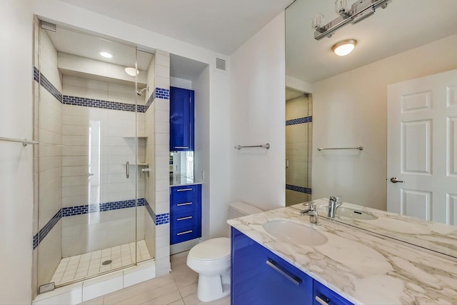 bathroom with vanity, an enclosed shower, and toilet