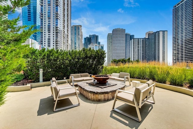 view of patio featuring an outdoor living space with a fire pit