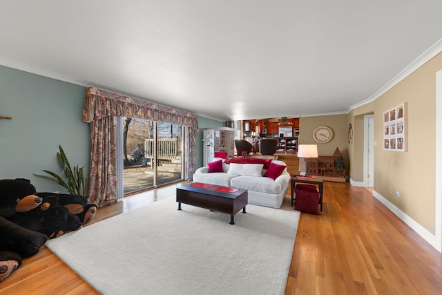 living room with crown molding and light hardwood / wood-style floors