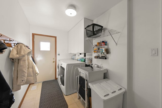 laundry area with light tile patterned flooring and washing machine and dryer