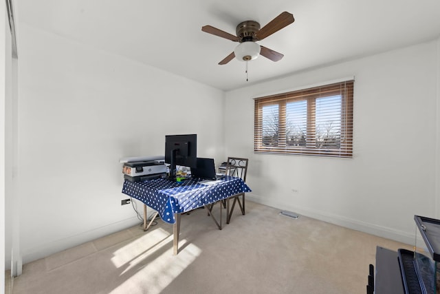 home office with light carpet and ceiling fan